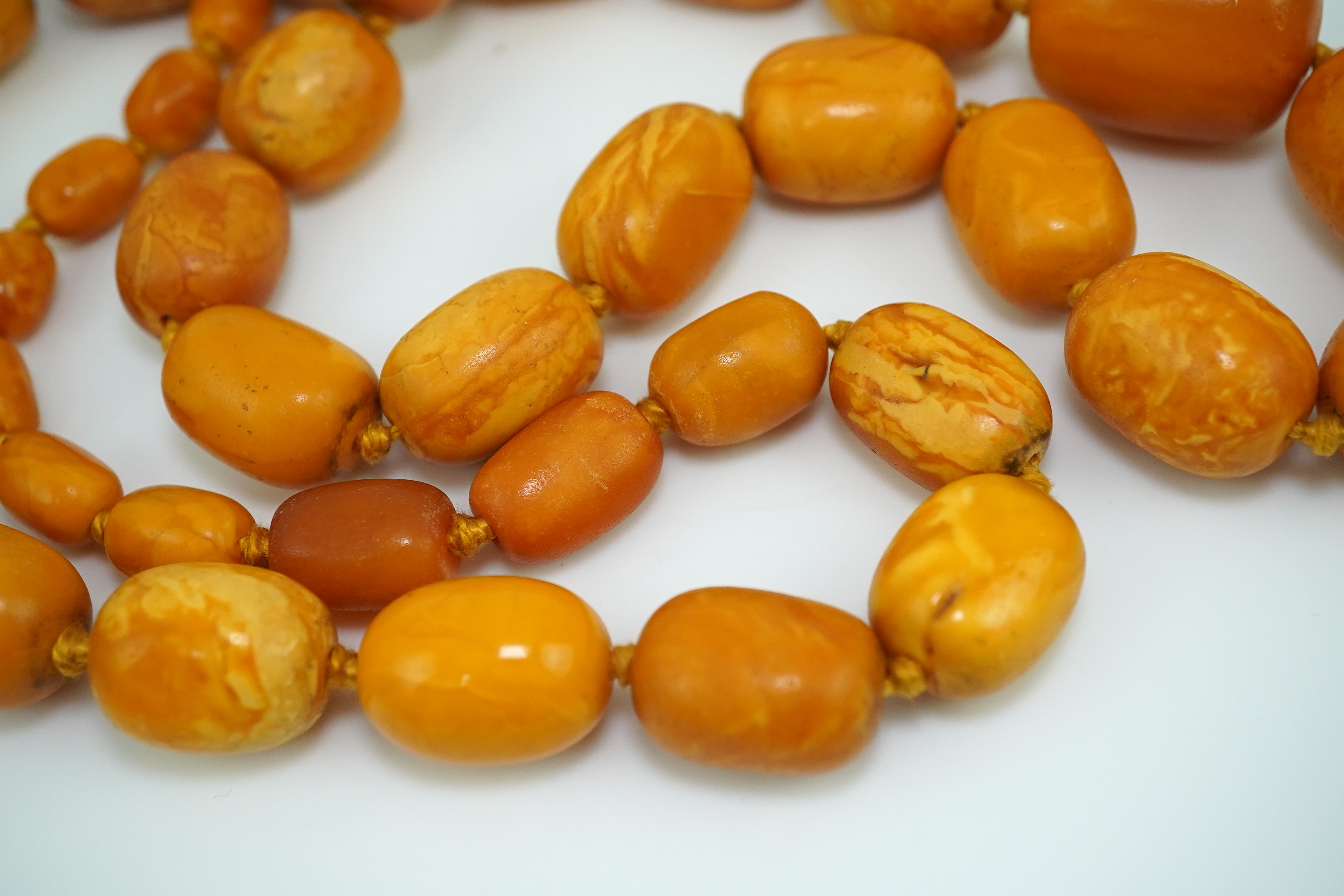 A single strand graduated oval amber bead necklace